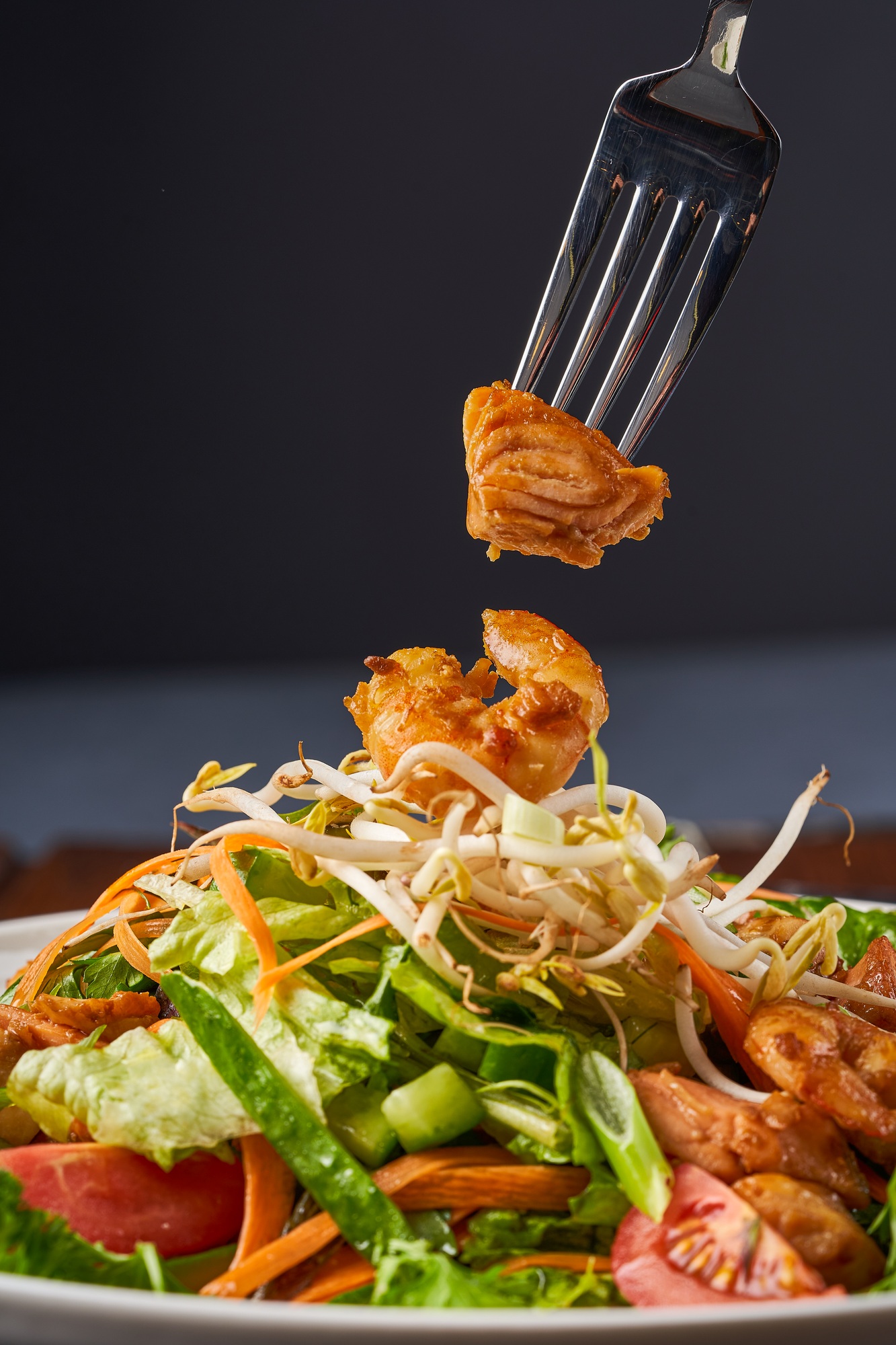 Close up photo of Seafood salad with shrimp, salmon, and fresh vegetables