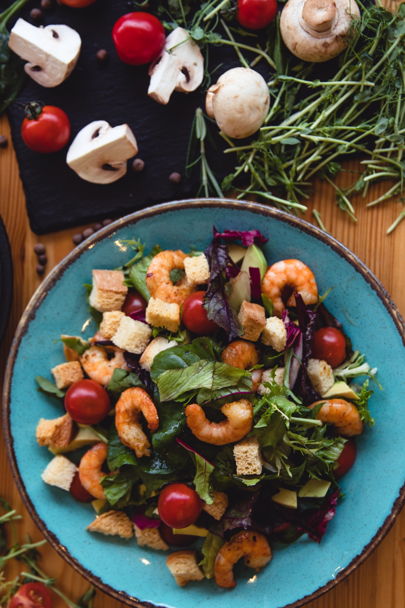Fresh salad plate with shrimp, tomato and mixed greens (arugula, mesclun