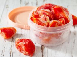 Containers with frozen tomatoes.