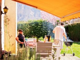 Guys time. Senior father and adult son enjoying barbecue on terrace of their summer house