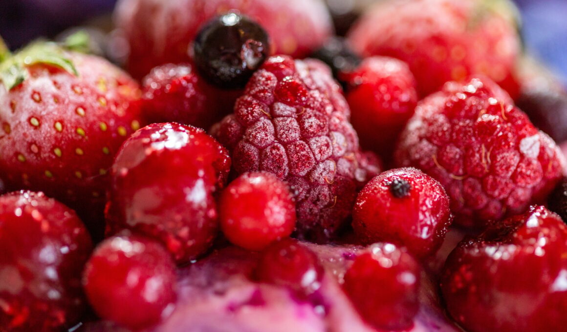 Closeup shot of a fruit shake topped with frozen yummy fruits