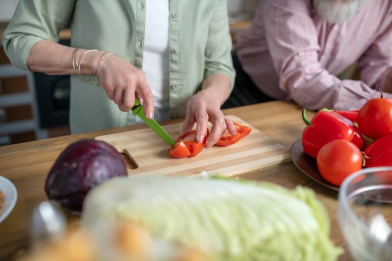 Woman cooking tomatoes for a vegetarian meal