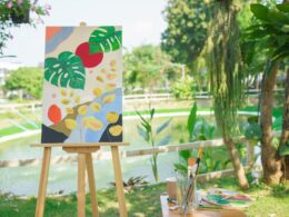 Creative art concept, Art masterpiece in canvas on easel with drawing equipment in the garden