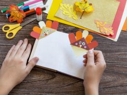 Thanksgiving craft bookmark turkey paper on a wooden table. Childrens art project.