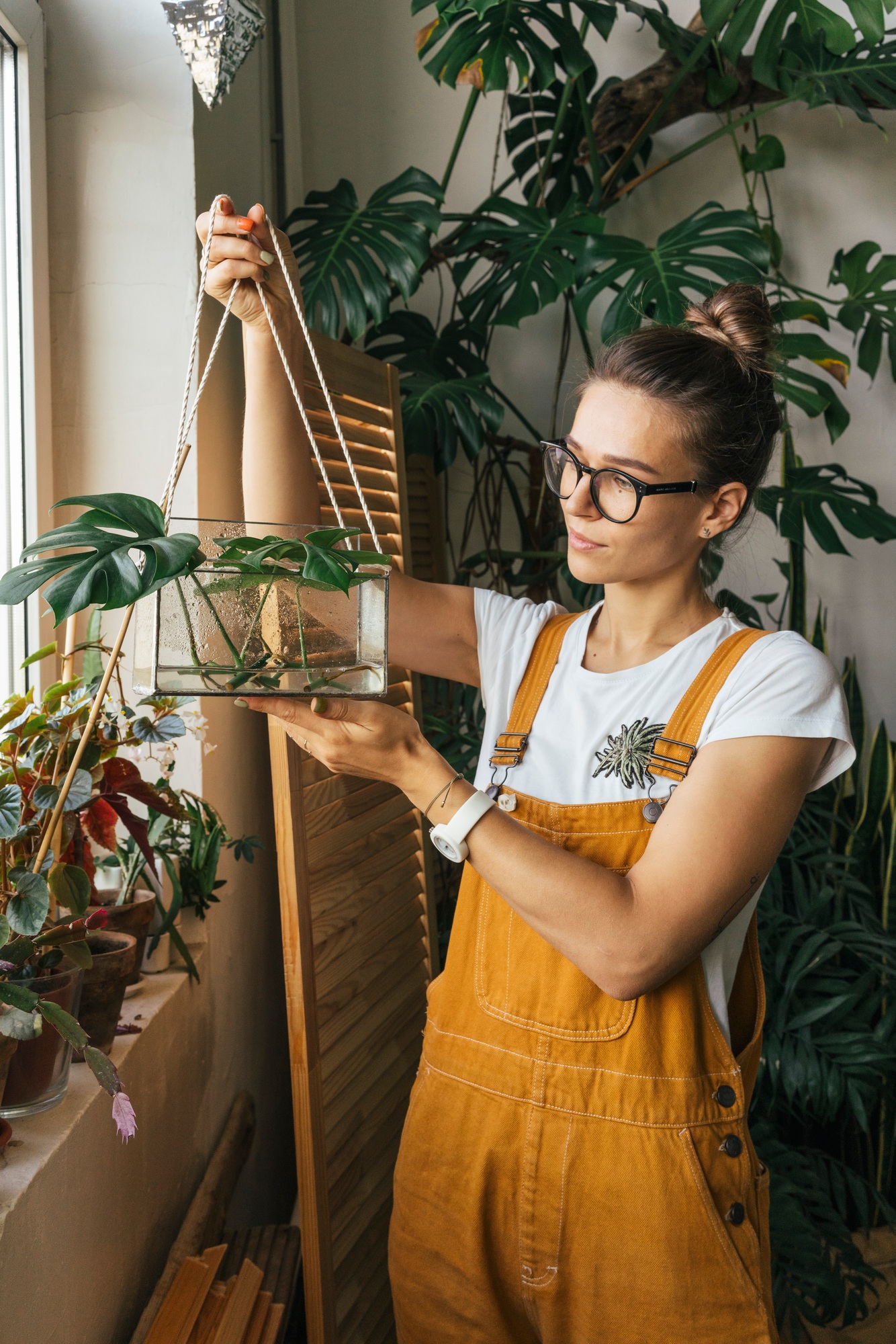 Young woman holding plant in a box with water