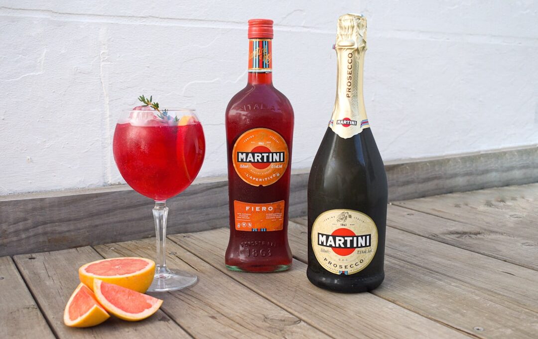 a bottle of martini next to a glass of wine