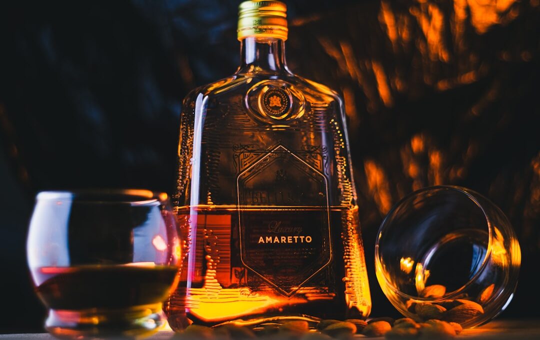 a bottle of amarbroto next to a glass of wine