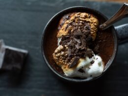 a cup of ice cream and chocolate on a table